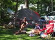 Family relaxing together at a campsite at Sutton Falls Campground in Massachusetts