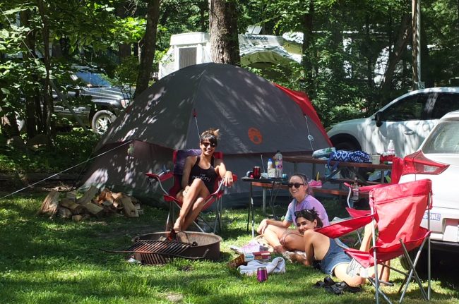 Family Camping Creates Lasting Memories at Sutton Falls Campground Family relaxing together at a campsite at Sutton Falls Campground in Massachusetts