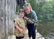 Parent and child showing a fish caught near the covered bridge at Sutton Falls Campground