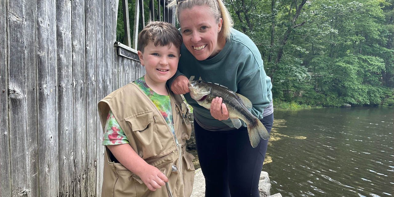 Family Camping Traditions at Sutton Falls Campground Parent and child showing a fish caught near the covered bridge at Sutton Falls Campground