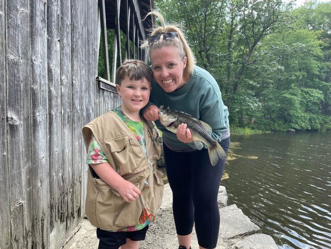 Family Camping Traditions at Sutton Falls Campground Parent and child showing a fish caught near the covered bridge at Sutton Falls Campground